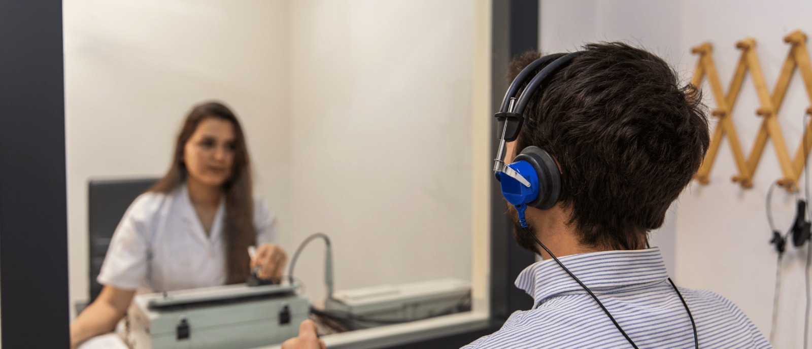 Audiologist performing a hearing test on a patient at Aanvii Hearing Clinic
